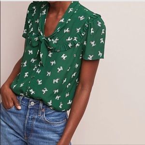 Anthropologie Maeve top in hunter green with dog pattern.